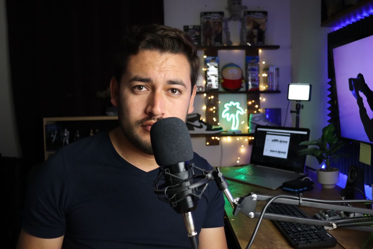 Podcaster in a stylish home studio with microphone and neon lights in Santiago de Querétaro, Mexico.