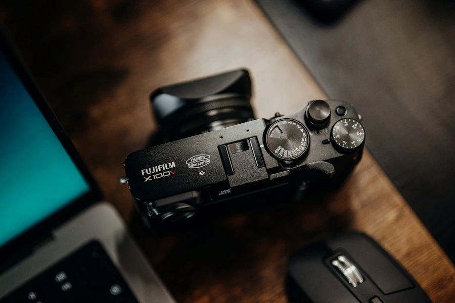 Camera on a desk beside a laptop, a sample post